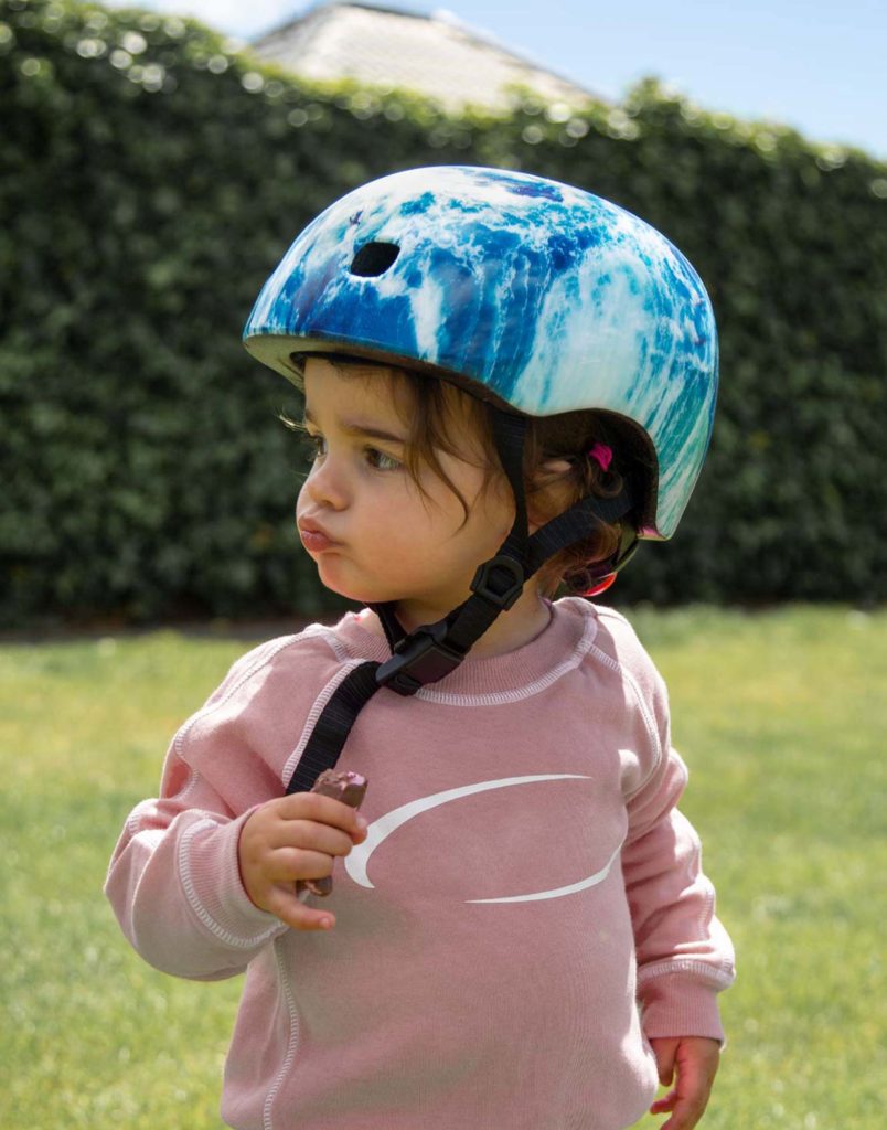 toddler at the park wearing ocean micro scooter bike helmet