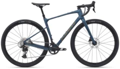 2024 Giant Revolt Advanced 1 Blue Ashes gravel bike leaning outdoors with SRAM Apex XPLR drivetrain and Maxxis Rambler tyres